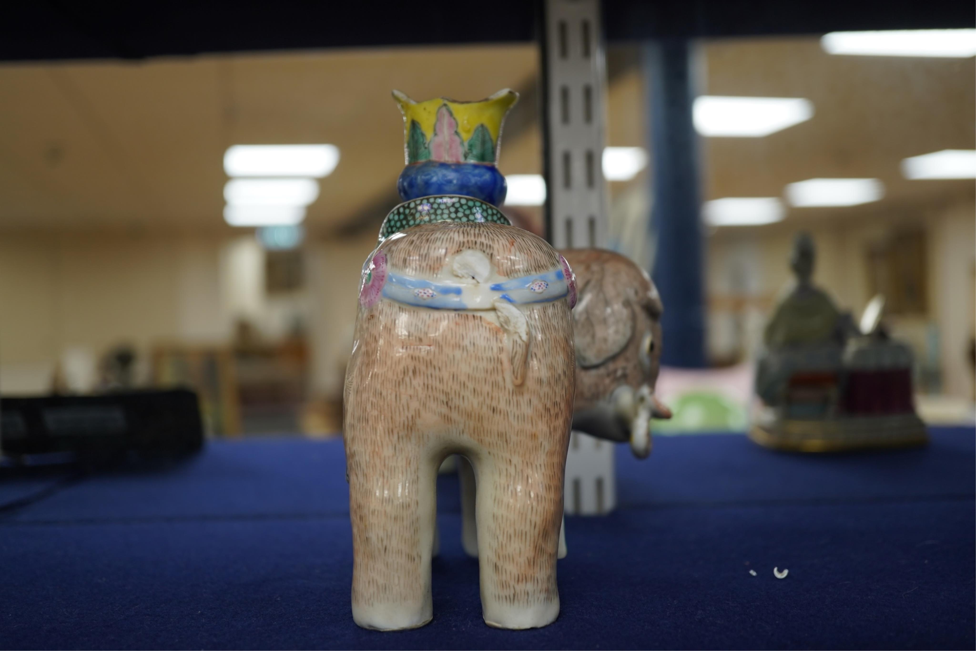 A 19th century Chinese enamelled porcelain vase in the form of an elephant with a howdah on its back